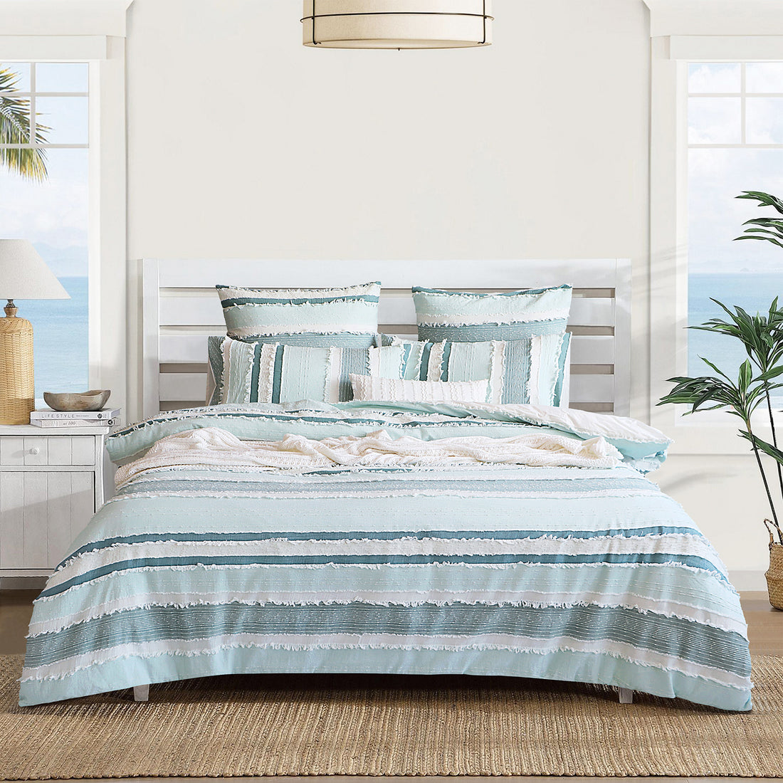 A beautifully made bed with All About Linen bedding
